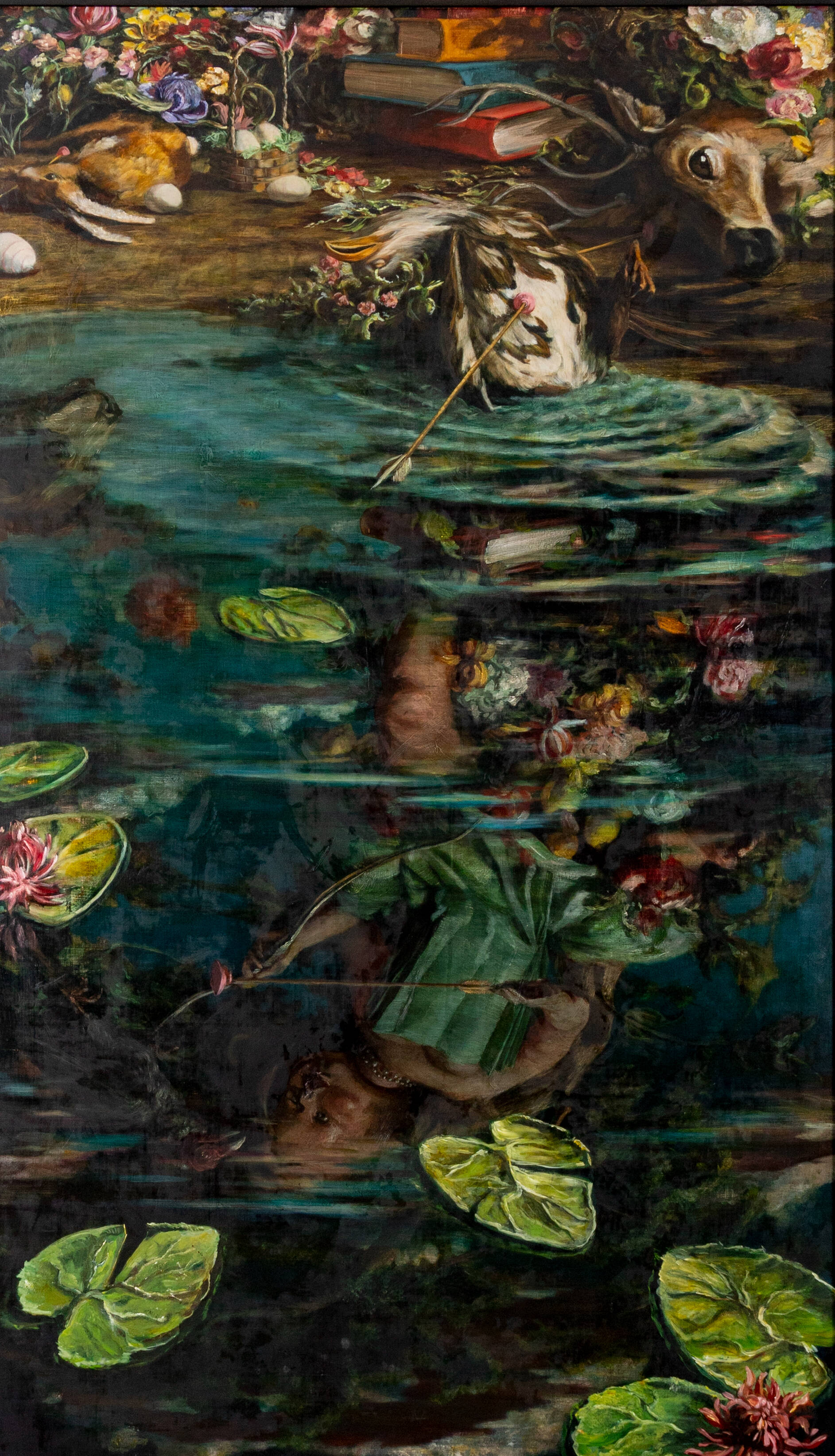Water with lily pads and reflections of doll with bow on land with books, flowers, and animals killed by suction-cup arrows.